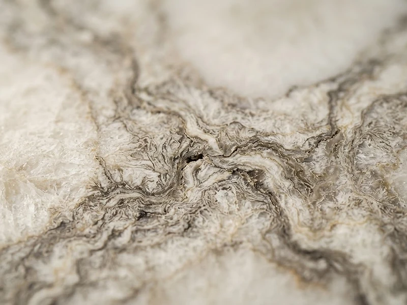 Macro study of marble grain, a tactile detail of Hasmar Interiors material palette